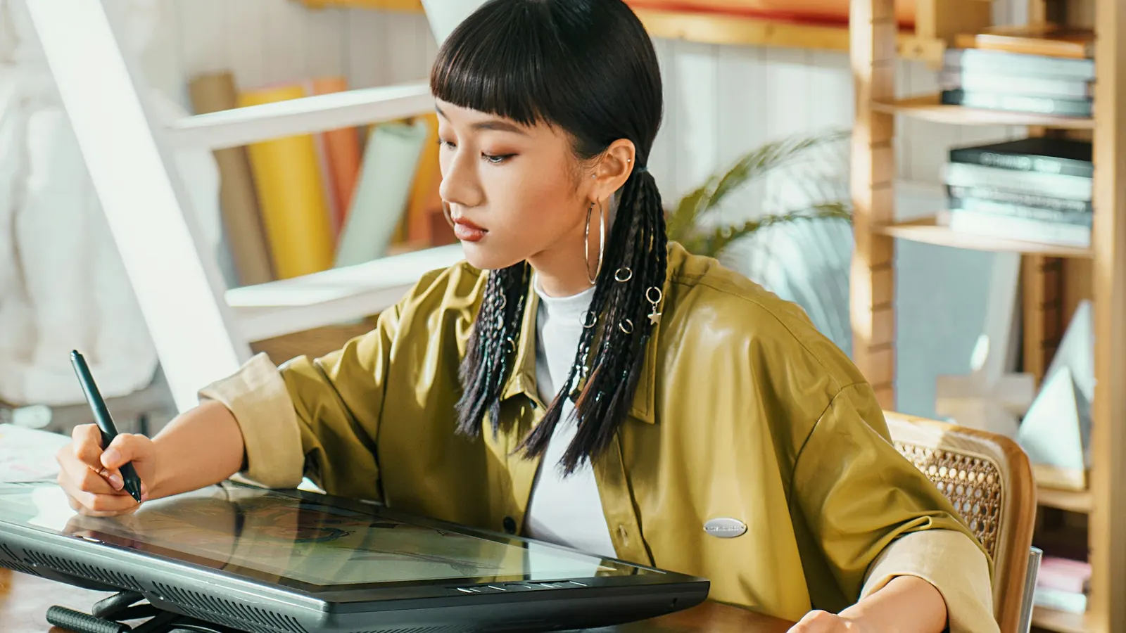 Graphic designer creating social media artwork on a pen display tablet