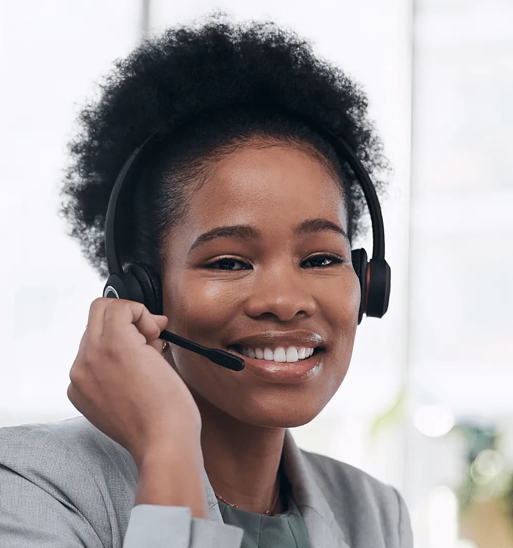 Smiling Bravura client support team member wearing a headset, ready to answer enquiries